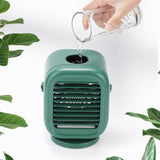 A lifestyle photo showing water being poured into the top of the green Aqualina companion water cooled desk fan.