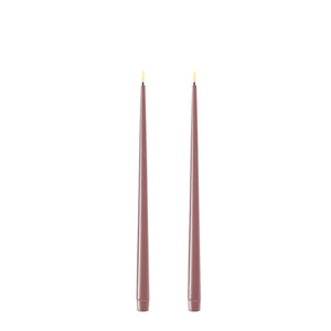Photo of 2 Light Purple 28cm tapered dinner candles. Their led flames are lit and they have black wicks.
