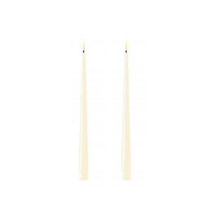 Photo of 2 cream coloured 28cm tapered dinner candles. Their led flames are lit and they have black wicks.