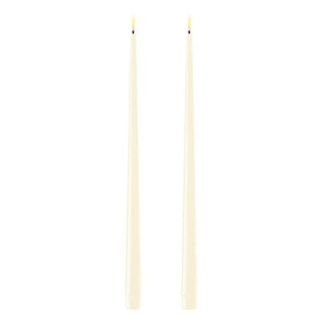 Photo of 2 cream coloured 38cm tapered dinner candles. Their led flames are lit and they have black wicks.