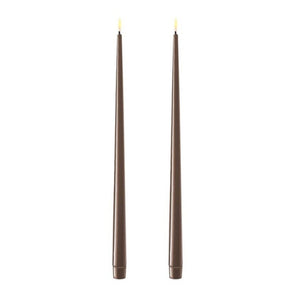 Photo of 2 mocha coloured 38cm tapered dinner candles. Their led flames are lit and they have black wicks.