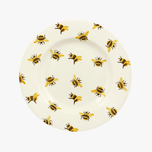 Photo of the Emma Bridgewater 8.5 inch plate. It has sponged bumblebees dotted all over the plate. These bumblebees have yellow wings.