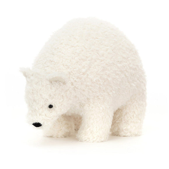Photo of a small Wistful Polar Bear cuddly toy from Jellycat. He has cream tight fur, with black nose and eyes. He is standing on all four legs and looking down. He has a big squidgy tummy. 