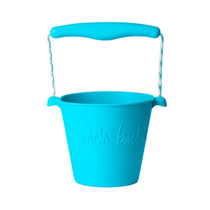 Photo of the Scrunch Bucket in Blue Sky, which is a bright blue. Its handle is made from a matching central piece of plastic and blue and white rope.