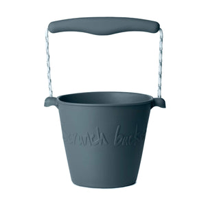 Photo of the Scrunch Bucket in French Navy. French Navy is a grey toned navy. Its handle is made from a matching central piece of plastic and french navy and white rope.