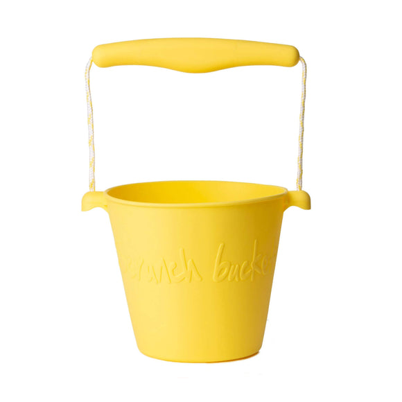 Photo of the Scrunch Bucket in Lemon Yellow. Its handle is made from a matching central piece of plastic and lemom and white rope.