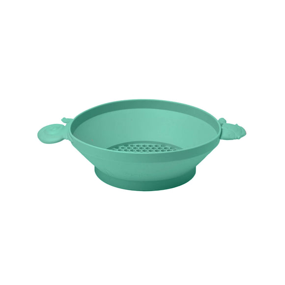 Photo of the Scrunch Panner in Teal Green. This silicone panner can be used to sieve soil or sand or for water play. One of the handles is shaped as a snail and the other a fish.
