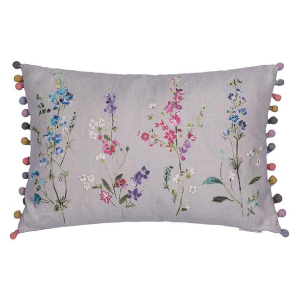 Image showing the 60x40cm Voyage Briella Silver Cushion. The image is four tall botanical flowers with multiple flowers on each. They are in shades of blue, purple and pink. On either end of the cushion are fabric covered beads in a variety of complementary pastel shades.